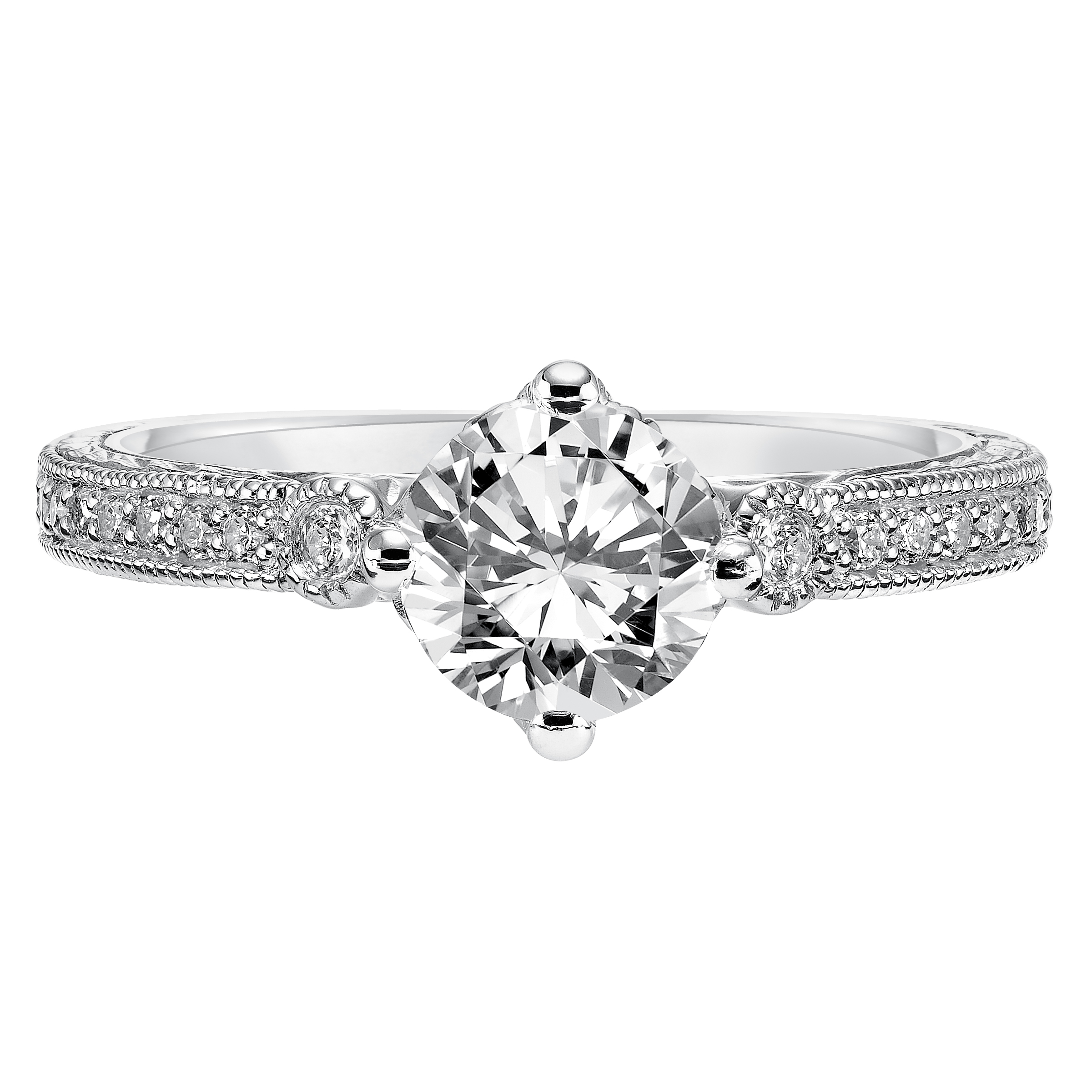 Prong set diamonds, milgrain details and an engraved design grace the band of this exquisite round diamond engagement ring
