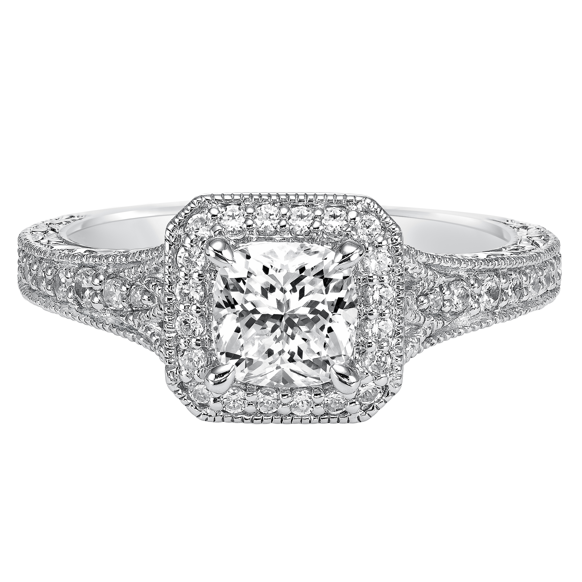 This cushion cut diamond engagement ring dazzles with its stunning prong set diamond halo and band enhanced with milgrain and an engraved design
